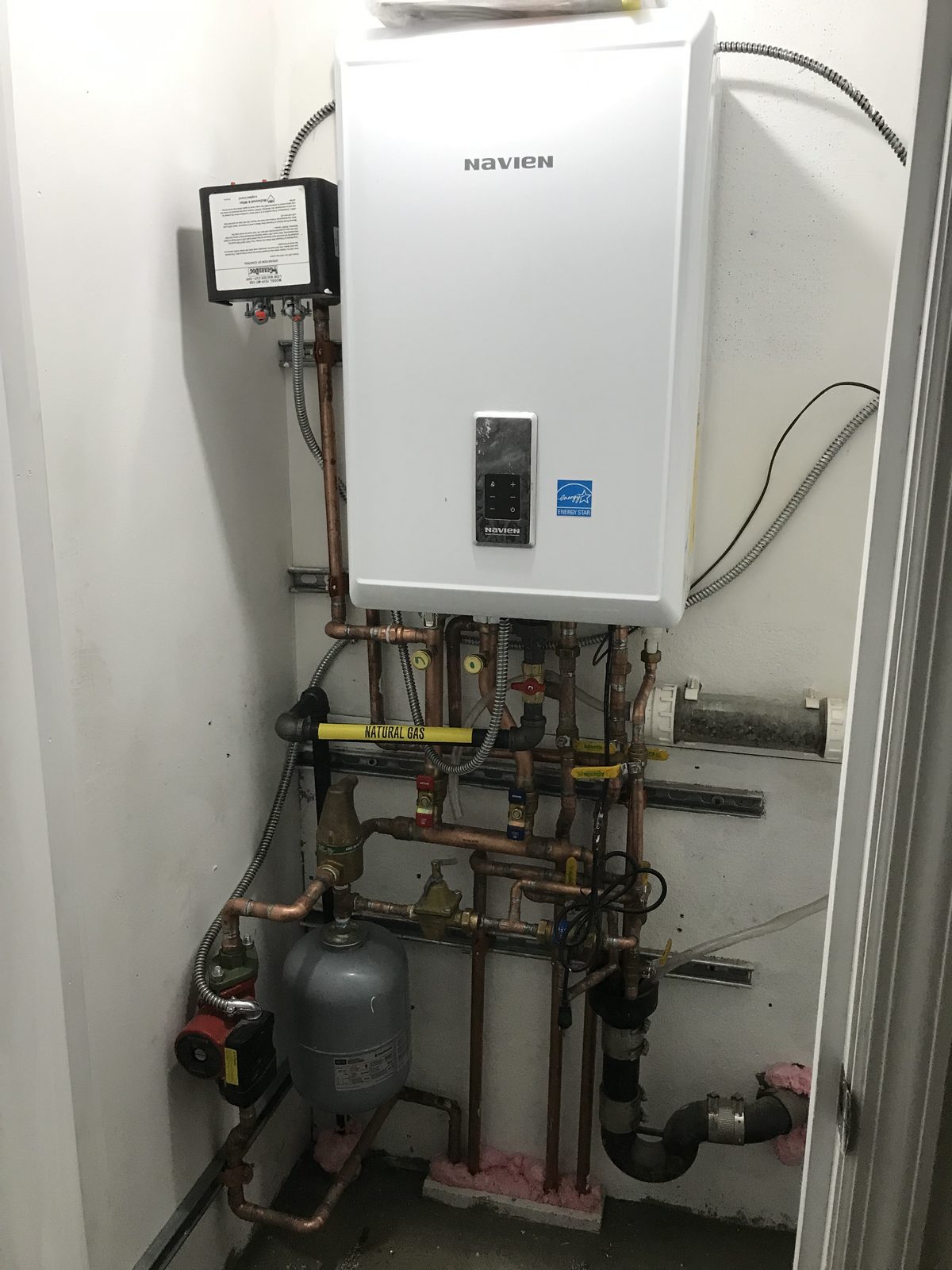 Combi boiler with a labeled natural gas line installed by I&I Plumbing
