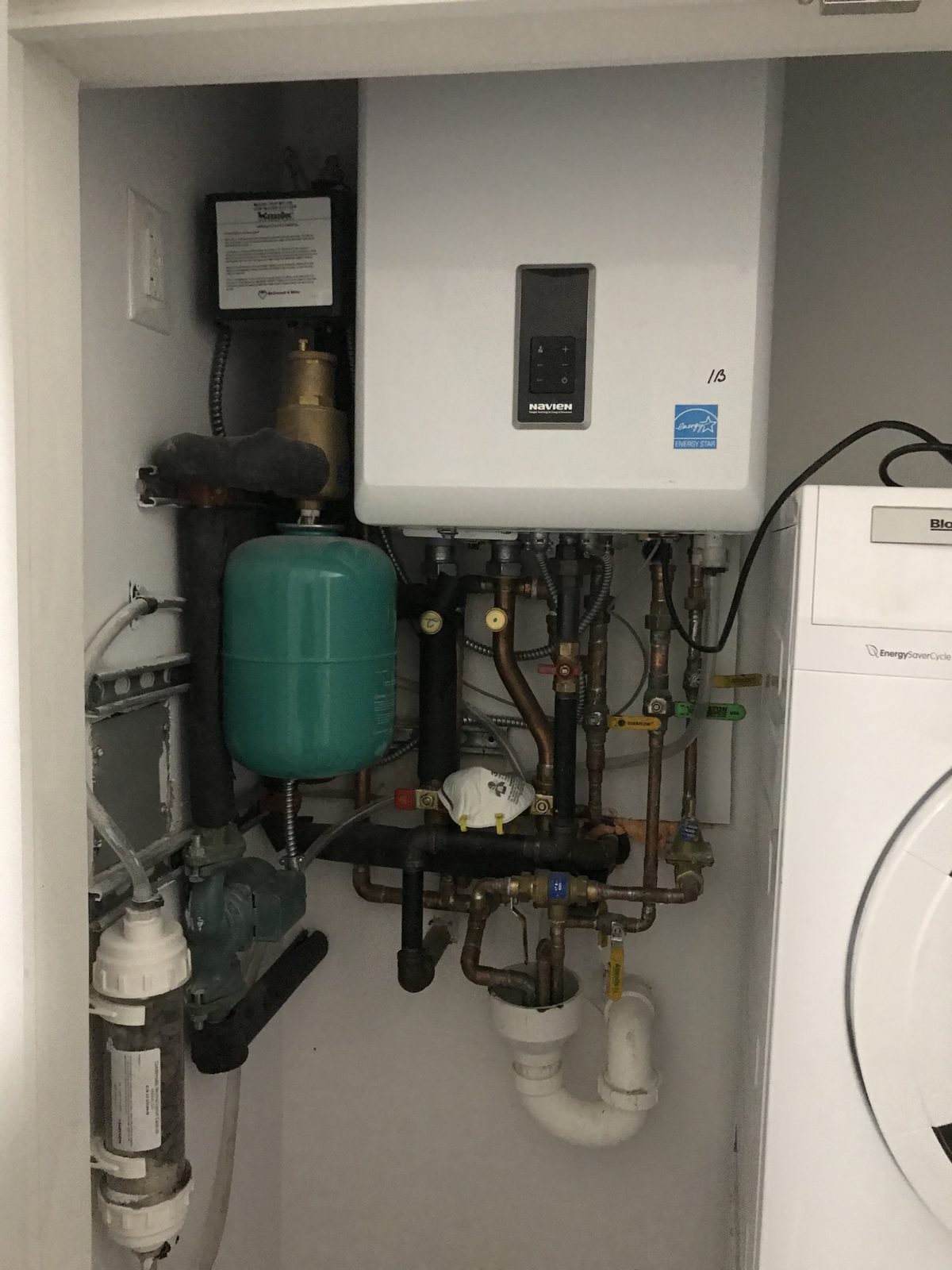 Combi boiler installed in a laundry closet by I&I Plumbing
