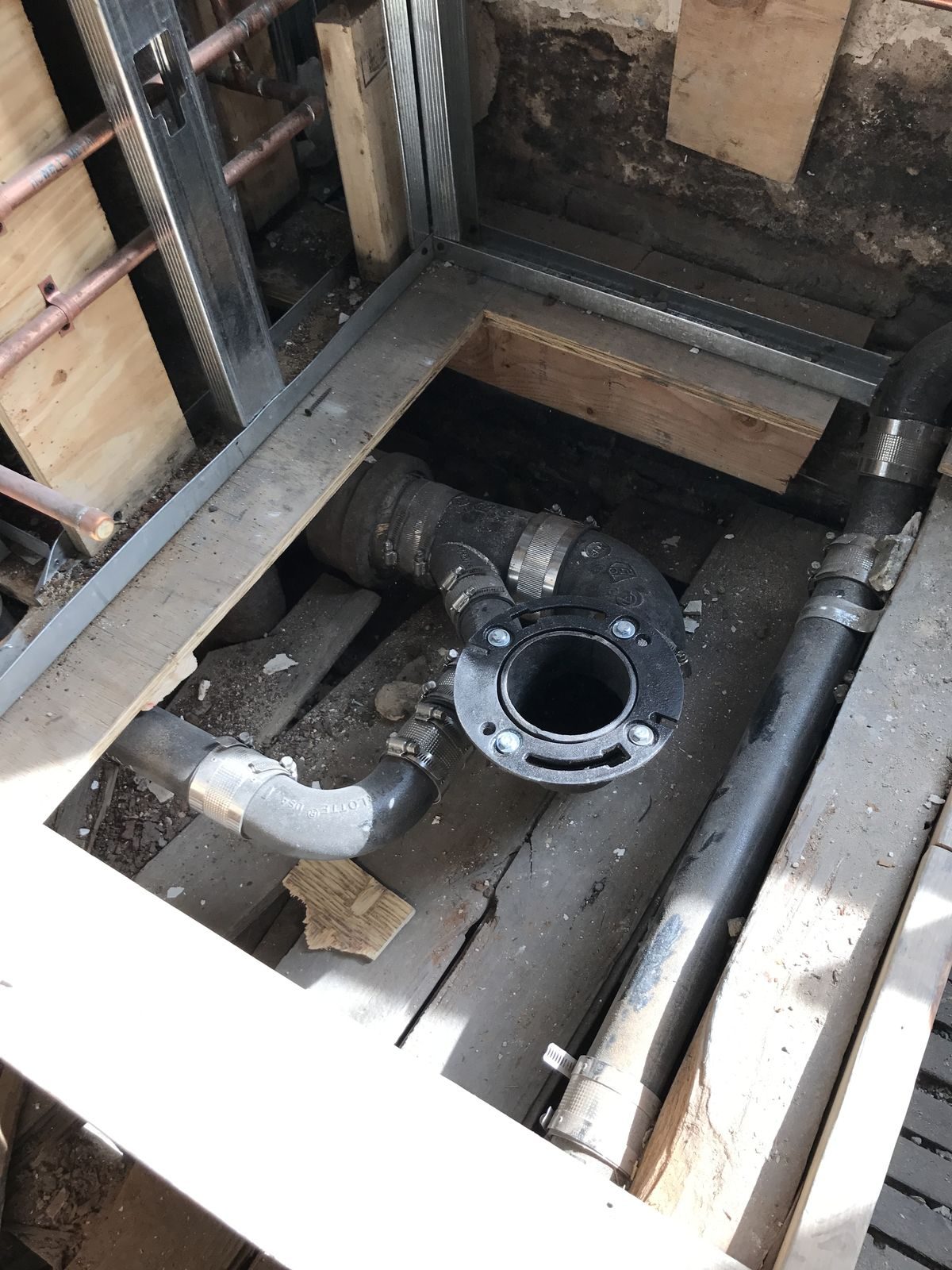 New gas piping run through an opened floor in an NYC building