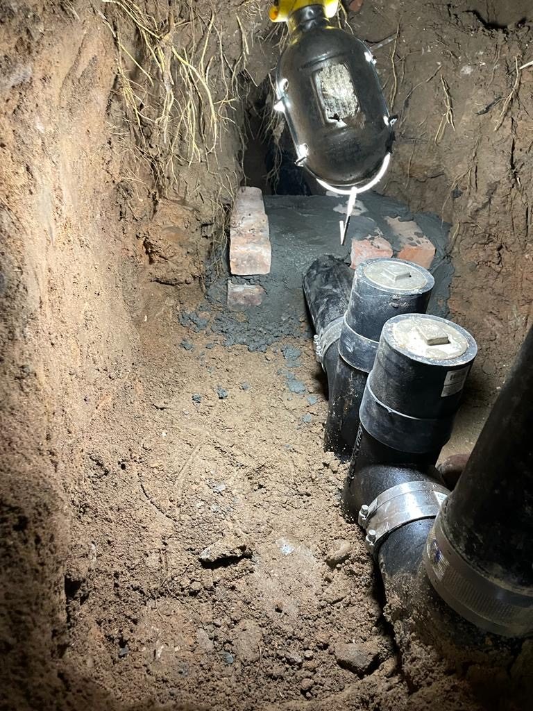 Sewer cleanouts set in an excavation by I&I Plumbing