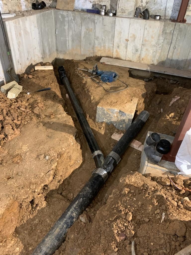 New underground drain lines in a trench, installed by I&I Plumbing